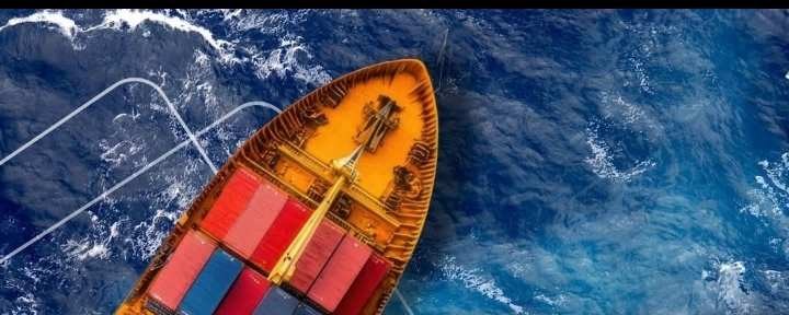 Aerial view of a loaded container ship at sea