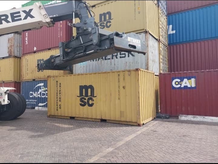 A reach stacker placing an MSC container in the port yard