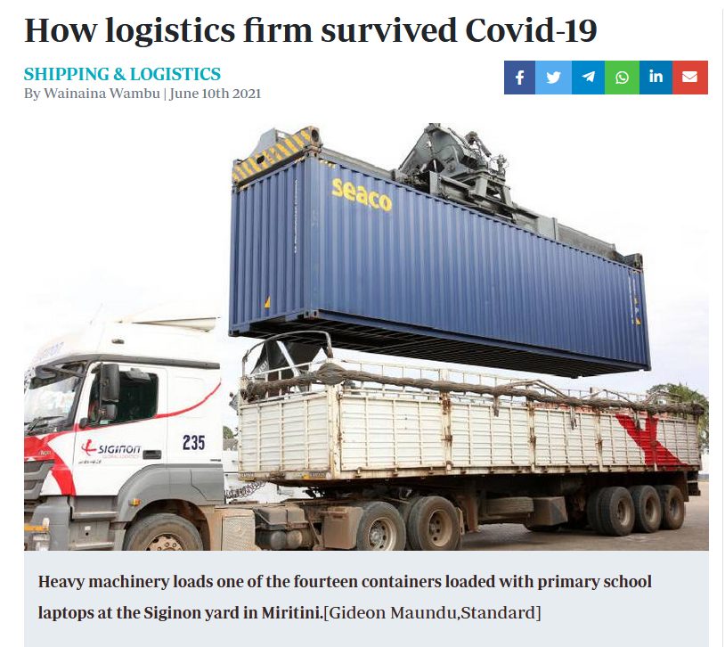 A truck carrying a shipping container