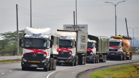 A convoy of container trucks on the highway