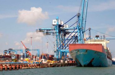 A cargo vessel berthed under the port cranes